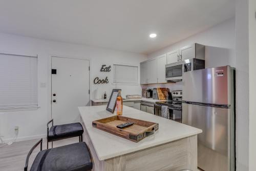 a kitchen with a counter with a refrigerator at Brand New Luxury Apt! Heart of Montrose- Downtown HTX in Houston