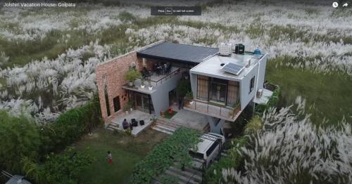 a house with a solar panel on top of it at Jolshiri Vacation House in Dhaka