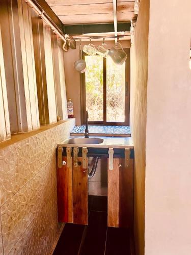 a kitchen with a sink and a window in it at Hermosa Nests in Playa Hermosa