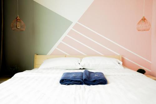 a bed with two blue shoes sitting on it at ITCC Manhattan Suites by Calvin in Donggongon