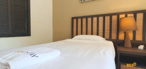 バンティングにあるGold Coast Morib Studio l Apartment I Penthouseのベッド(白いシーツ、木製のヘッドボード付)