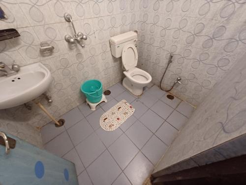 a small bathroom with a toilet and a sink at Hotel V inn Sindhi Camp in Jaipur