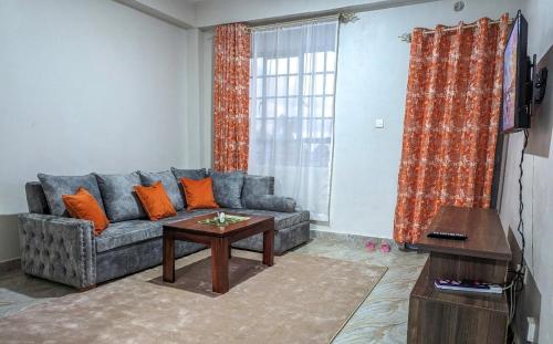 a living room with a couch and a table at Cozy Homestays Meru in Meru