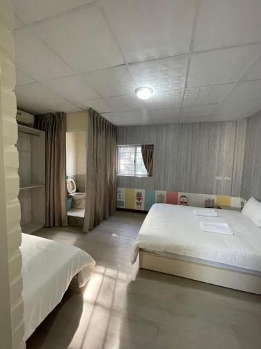 Ένα ή περισσότερα κρεβάτια σε δωμάτιο στο Yilan B&B