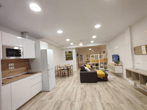 cocina y sala de estar con sofá y mesa en Aloja Córdoba en Córdoba