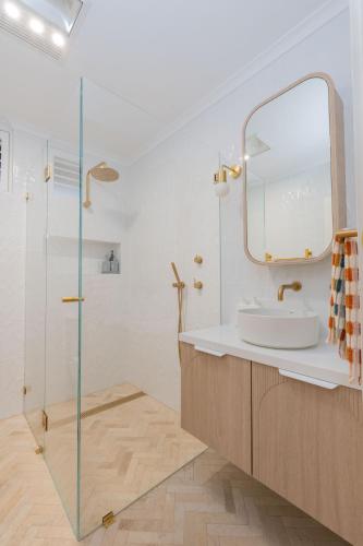 a bathroom with a sink and a mirror at Seaside Villa Steps to Beach, Cafes, Boutiques in Brighton