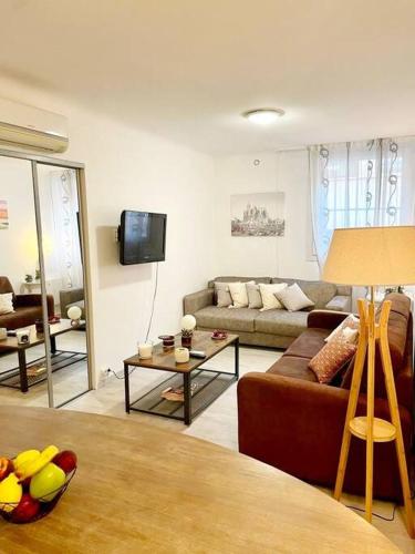 a living room with a couch and a table at Cœur de Cannes in Cannes