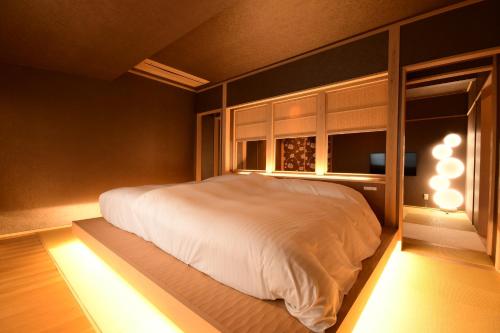 a bedroom with a white bed and a window at 鵜原館 -Ubarakan- in Katsuura