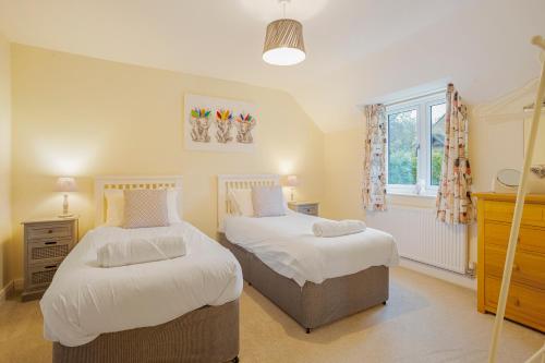 A bed or beds in a room at Staddlestone Mews