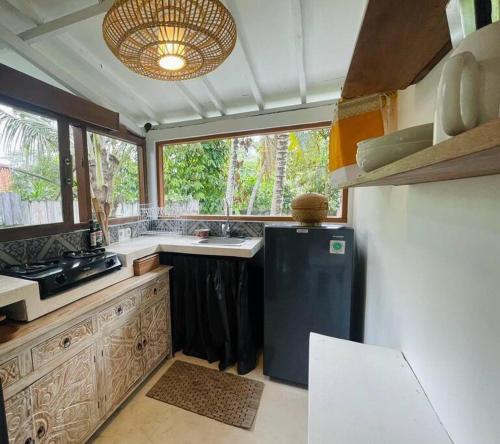 a kitchen with a blue refrigerator and a window at villa kayu keluarga lilas in Ubud