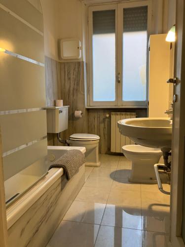 a bathroom with a sink and a toilet at Monti Parioli House in Rome