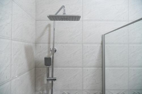 a shower with a shower head in a bathroom at Chateau Milisi in Batumi