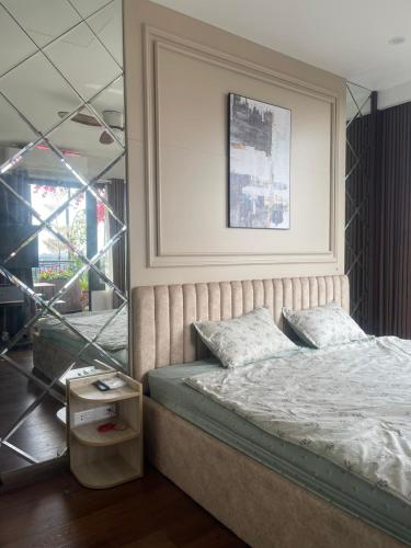 a bedroom with a bed and a table and a mirror at ND Happy House 1- CH sân vườn, CH chuẩn khách sạn tại số 10 ngách 5 ngõ 56 Hoa Lâm, Hà Nội in Hanoi