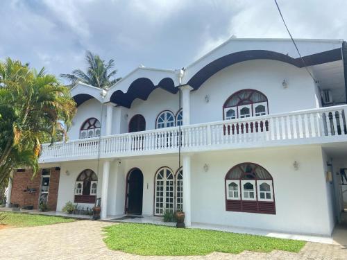 a white house with a balcony at New White House in Aluthgama