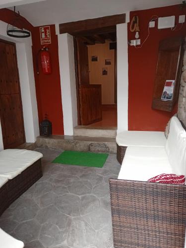 a room with two beds and a green rug at El Canchal de Eladia in Valdeverdeja