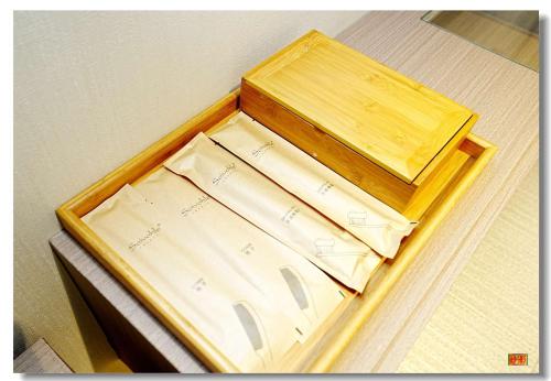 a wooden box sitting on top of a bed at pristine 1 in Manila