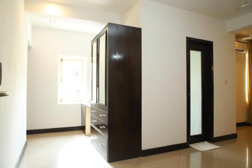 a large black cabinet in a room with a window at Casabela Boutique Hotel in Porvorim