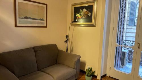 a living room with a couch and a window at Caravaggio Apartment in Naples