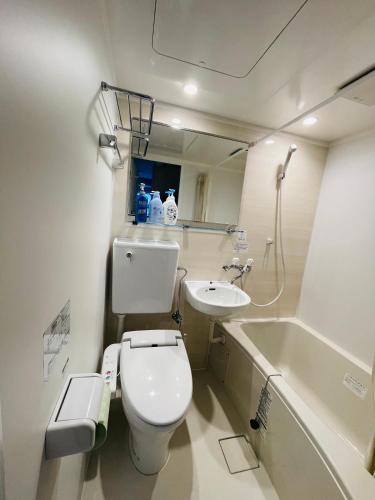 a bathroom with a toilet and a sink and a tub at home Shinjuku west101 in Tokyo