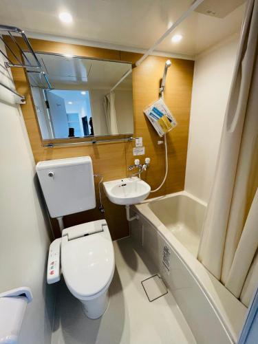 a small bathroom with a toilet and a sink at home Shinjuku west302 in Tokyo
