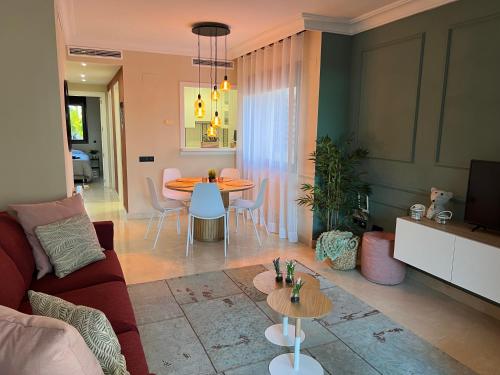 a living room with a red couch and a table at Casa André - 3 Bedroom Roda Golf apartment nearby entrance and clubhouse in Roda