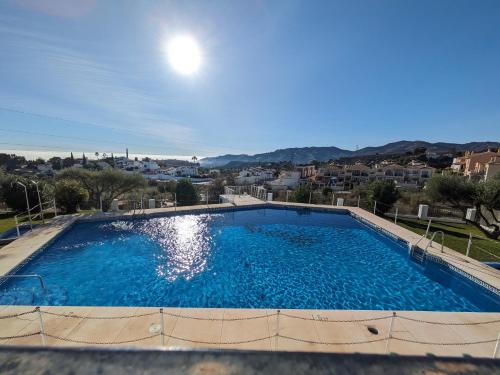 a large swimming pool with a view of a city at Chalet La Noria in Nerja
