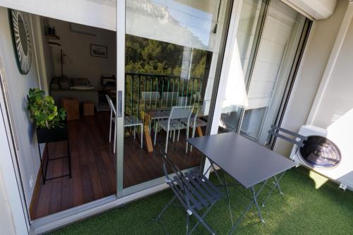 un balcon avec une table et des chaises sur une terrasse dans l'établissement Grand appartement T2, lumineux, au calme, au pied des Calanques, proche Mer, à Marseille