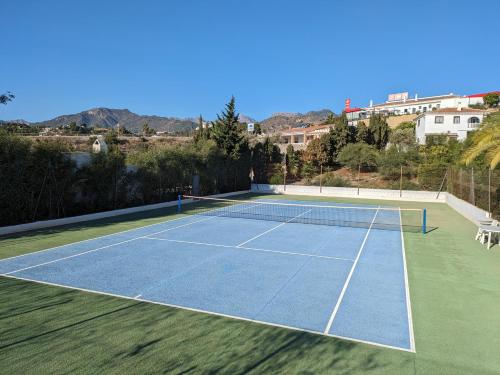a tennis court with a tennis racket on it at Chalet La Noria in Nerja