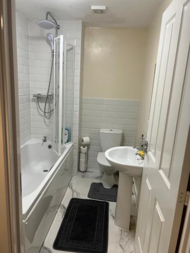 a white bathroom with a toilet and a sink at Soweway Coventry in Coventry