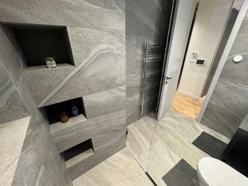 a bathroom with a shower and a toilet at Cadordzina Apartment Free Parking Old Town in Sarajevo