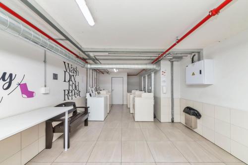 a room with white walls and white toilets at Mountain View Apartment at Woodstock Quarter in Cape Town