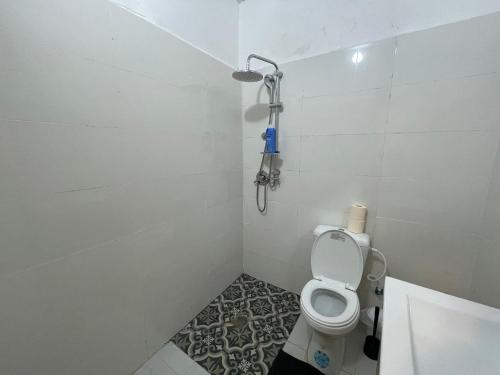 a small bathroom with a toilet and a shower at עלמה in Tel Aviv