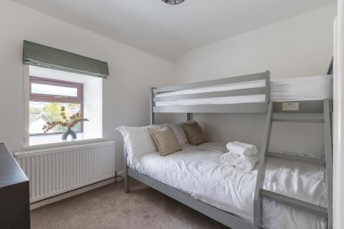 a bedroom with a bunk bed and a window at Home in Llanberis in Llanberis
