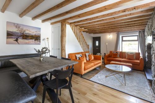 a living room with a table and a couch at Home in Llanberis in Llanberis