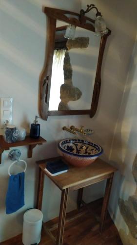 a bathroom with a sink and a mirror at Casas Quo Vadis -Azul in Lugo