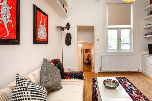 a living room with a couch and a table at Italianflat - Kilburn Art Style in London