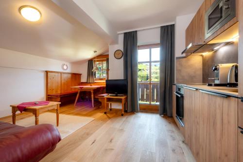 a kitchen and living room with a couch and a table at Villa Agricola in Kaprun