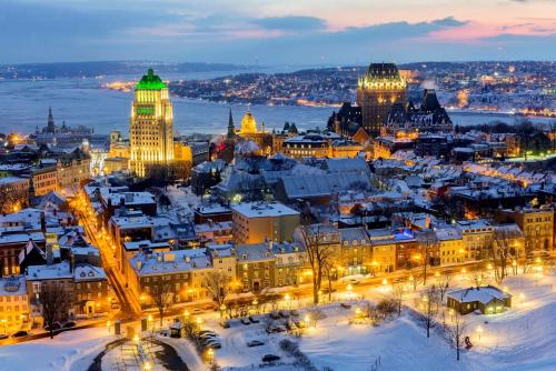 a city lit up in the snow at night at 6 people, big, free parkings, near Old Quebec, near river in Quebec City