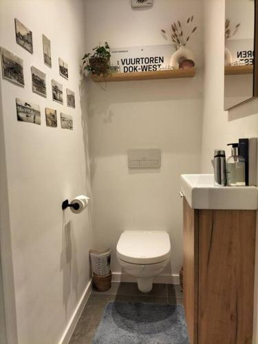 a bathroom with a white toilet and a sink at Sea la vie in Ostend