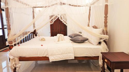 Katil atau katil-katil dalam bilik di Tropical Inn