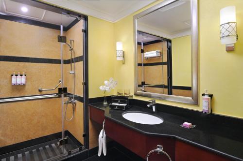 a bathroom with a sink and a shower at Mövenpick Hotel City Star Jeddah in Jeddah