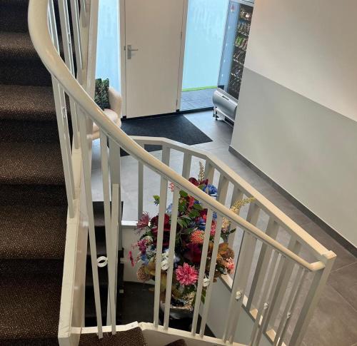 a stairway with a bunch of flowers on it at The Residence Apeldoorn in Apeldoorn