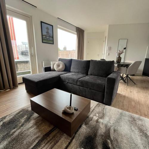 a living room with a couch and a coffee table at The Residence Apeldoorn in Apeldoorn