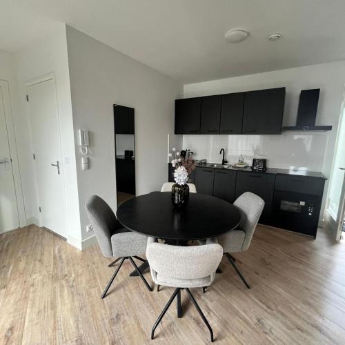 a kitchen and dining room with a table and chairs at The Residence Apeldoorn in Apeldoorn