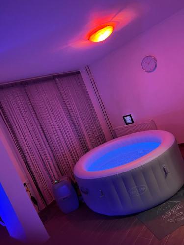 a bathroom with a large tub in a purple room at LUXSPAKR in Kranj