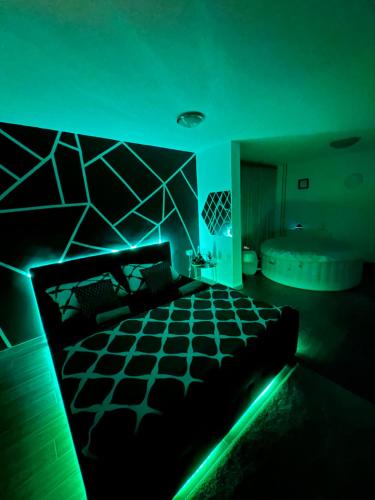 a dark room with a bed and a tub at LUXSPAKR in Kranj