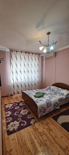 a bedroom with a bed and a ceiling at Sweet Home 2 in Atyrau