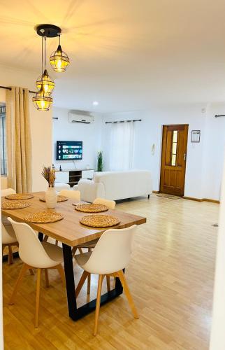 a dining room and living room with a table and chairs at Luxury Modern Home in Summerstrand