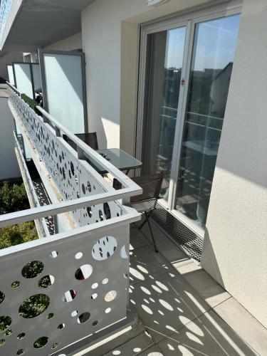 a balcony with stairs and a table on a building at T2 proche stade de Frace Paris très calme design in Bobigny