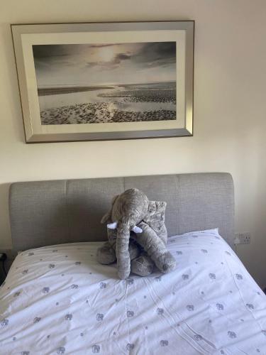 a teddy bear sitting on top of a bed at Princes Risborough, Buckinghamshire, comfortable double room, quiet and central location in Buckinghamshire